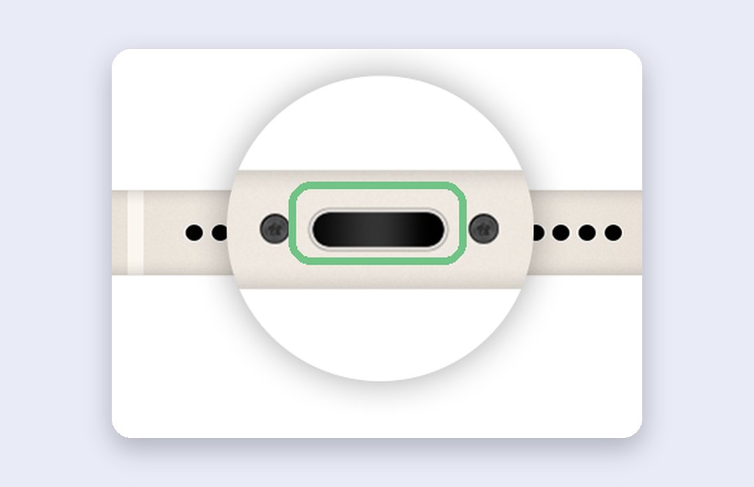 Close-up of the bottom edge of an iPhone showing the charging port between the speaker and microphone holes